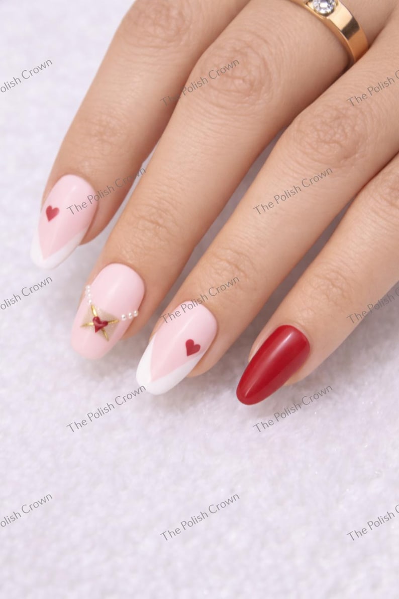 May include: A hand with manicured nails. Some nails are painted light pink with white tips and red hearts. One nail is solid red. The Polish Crown is printed on the background.