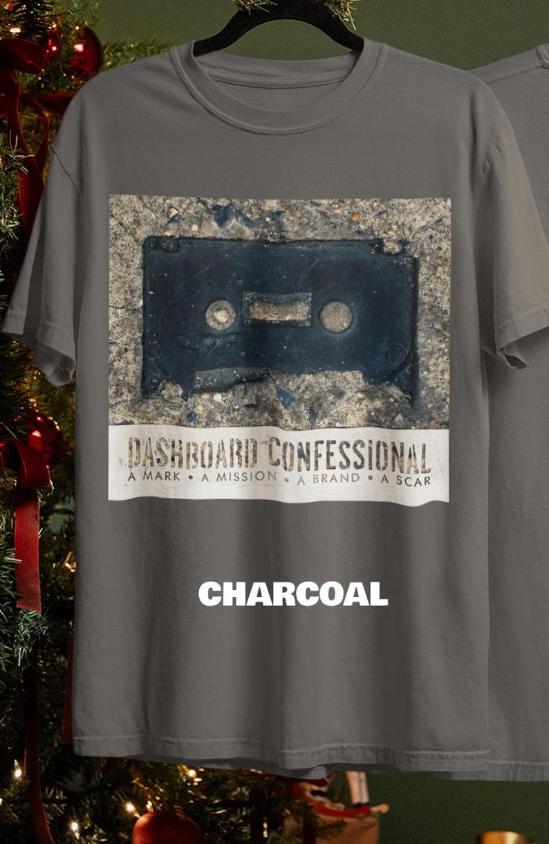 May include: Charcoal gray t-shirt featuring a distressed image of a cassette tape. Below the image is the text "DASHBOARD CONFESSIONAL" and the words "A MARK &bull; A MISSION &bull; A BRAND &bull; A SCAR". The word "CHARCOAL" is printed at the bottom.