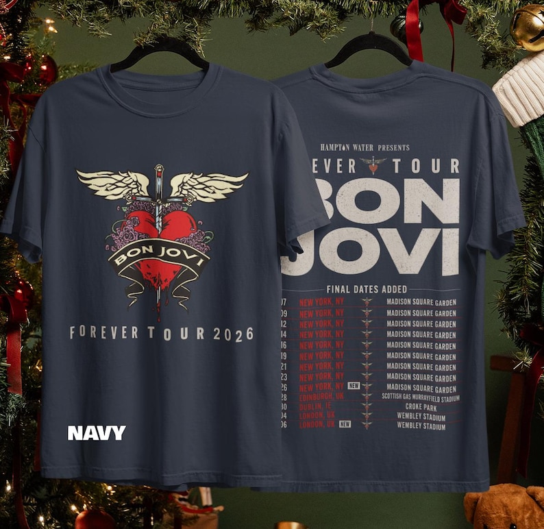 May include: A navy blue t-shirt featuring a graphic of a red heart pierced by a sword with wings on the front, and the text Bon Jovi Forever Tour 2026. The back displays tour dates and venues for the Hampton Water Presents Forever Tour.
