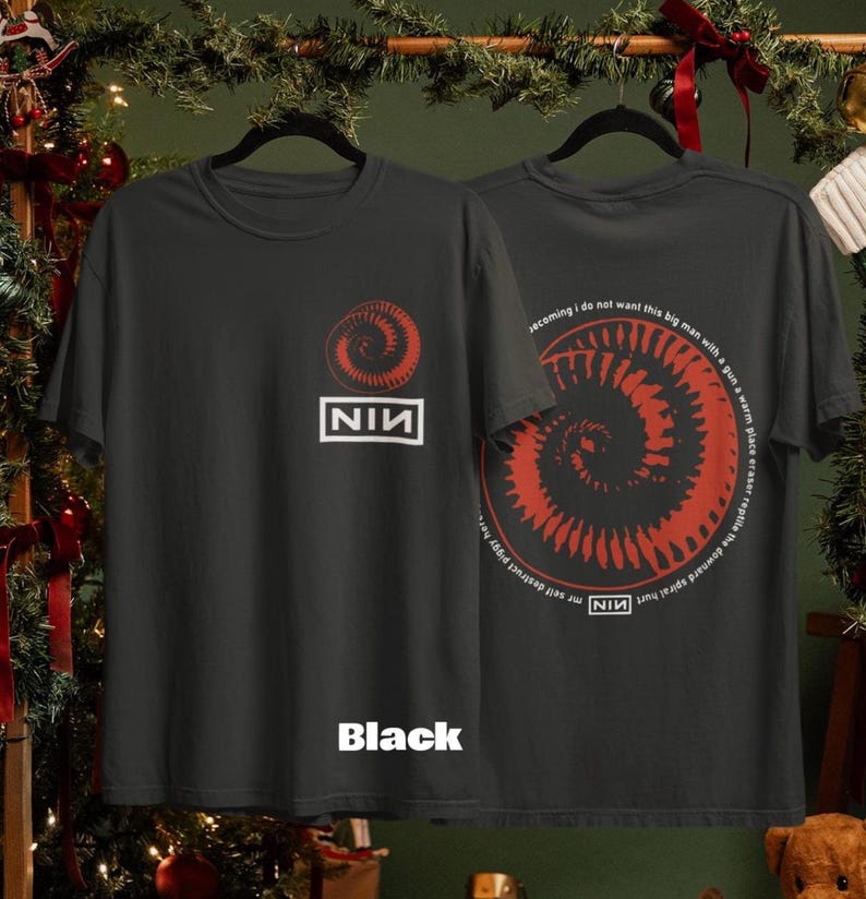 May include: Black t-shirt featuring a red spiral design and the text "NIN" in a white rectangle. The back of the shirt displays a similar spiral design with additional text. The word "Black" is printed at the bottom of the shirt.