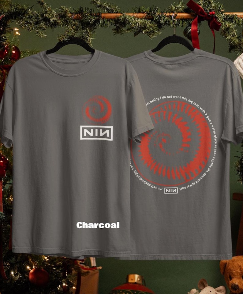 May include: Charcoal gray t-shirts with a red spiral design and the text "NIN". One shirt displays the NIN logo and a red circle. The other shirt has a spiral design and text. The word "Charcoal" is printed on the front.