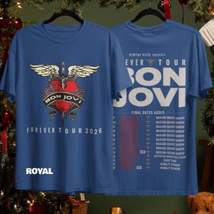 May include: A royal blue t-shirt featuring a front graphic of a red heart pierced by a sword with wings and the text "BON JOVI FOREVER TOUR 2026". The back displays "HAMPTON WATER PRESENTS FOREVER TOUR BON JOVI" with a list of tour dates.