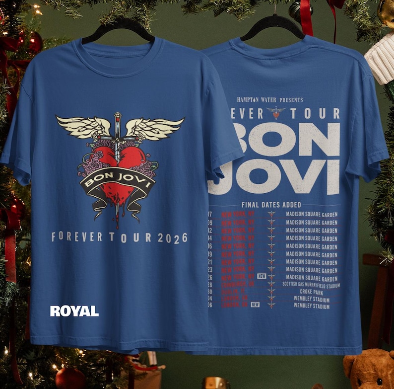 May include: A royal blue t-shirt featuring a front graphic of a red heart pierced by a sword with wings and the text "BON JOVI FOREVER TOUR 2026". The back displays "HAMPTON WATER PRESENTS FOREVER TOUR BON JOVI" with a list of tour dates.