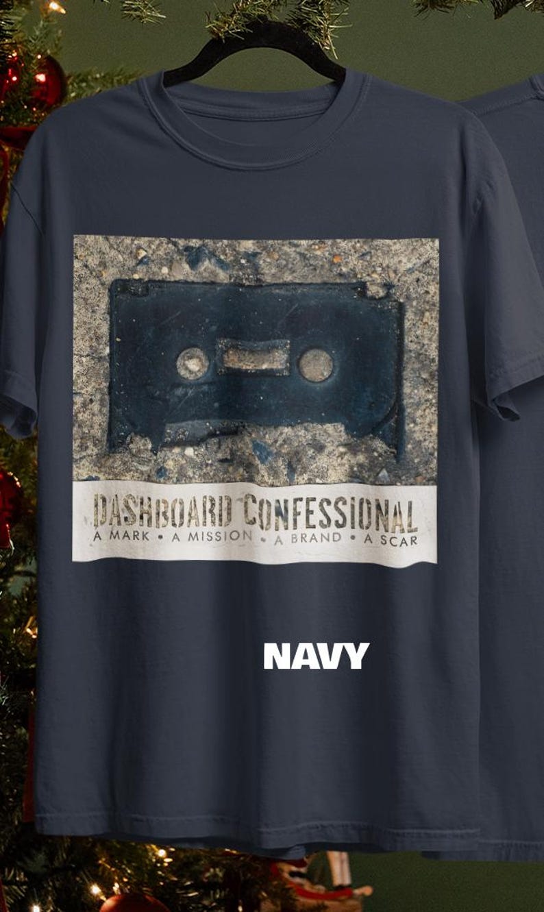 May include: Navy blue t-shirt featuring a distressed image of a cassette tape. Below the image is the text "DASHBOARD CONFESSIONAL" and the words "A MARK &bull; A MISSION &bull; A BRAND &bull; A SCAR". The word "NAVY" is printed in white.