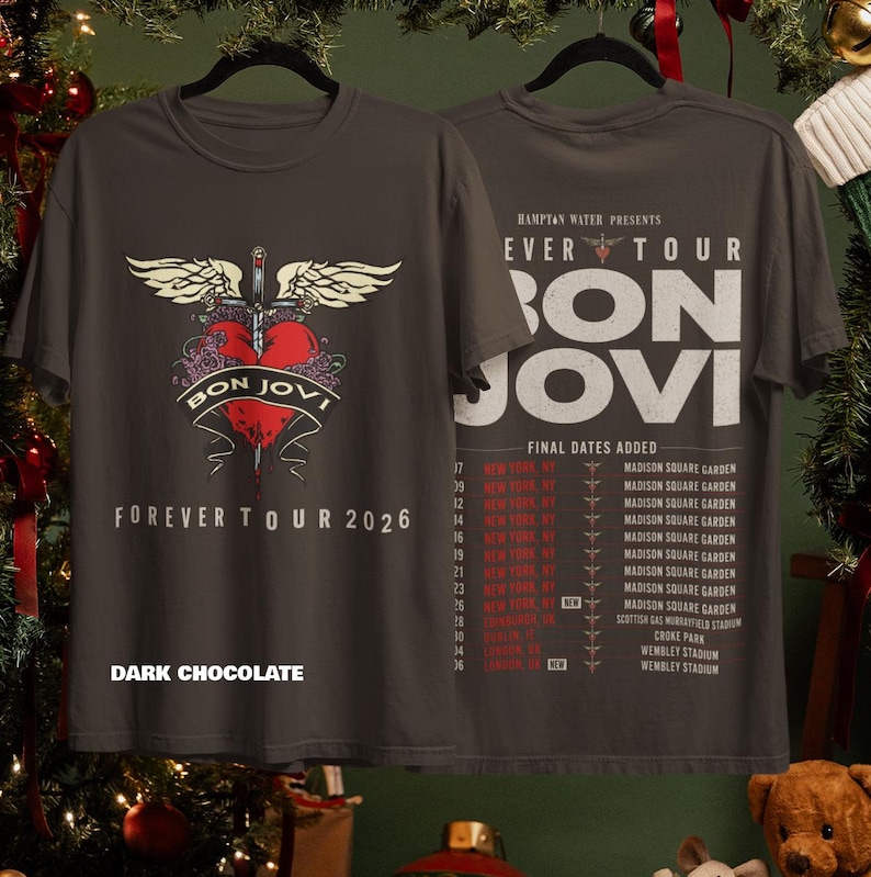 May include: A dark chocolate colored t-shirt featuring a front graphic of a red heart pierced by a sword with wings and the text Bon Jovi Forever Tour 2026. The back displays the tour schedule with dates and locations including Madison Square Garden.