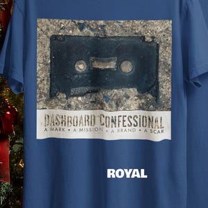 May include: Royal blue t-shirt featuring a graphic of a black cassette tape on a textured background. The text "DASHBOARD CONFESSIONAL" is above the text "A MARK A MISSION A BRAND A SCAR". The word "ROYAL" is below the graphic.