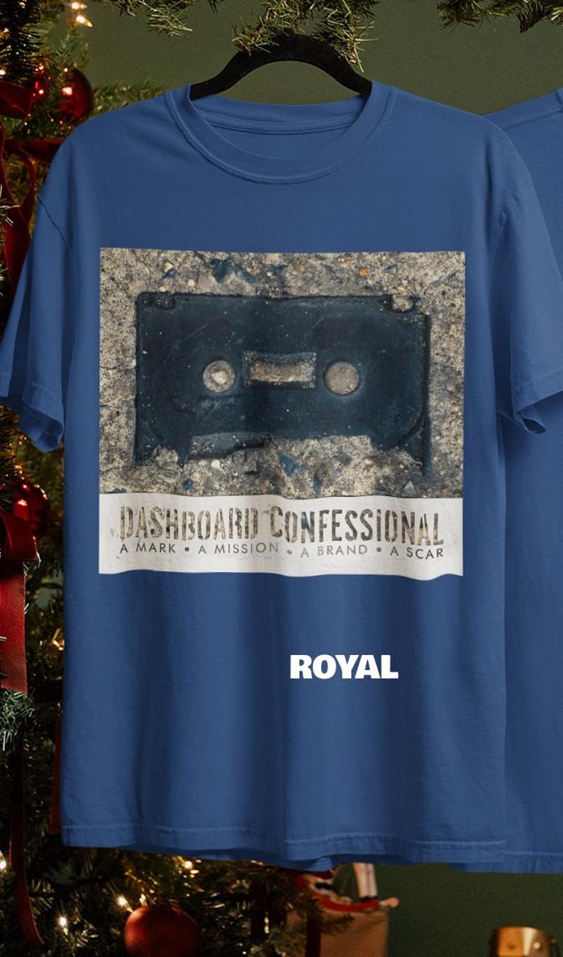 May include: Royal blue t-shirt featuring a graphic of a black cassette tape on a textured background. The text "DASHBOARD CONFESSIONAL" is above the text "A MARK A MISSION A BRAND A SCAR". The word "ROYAL" is below the graphic.