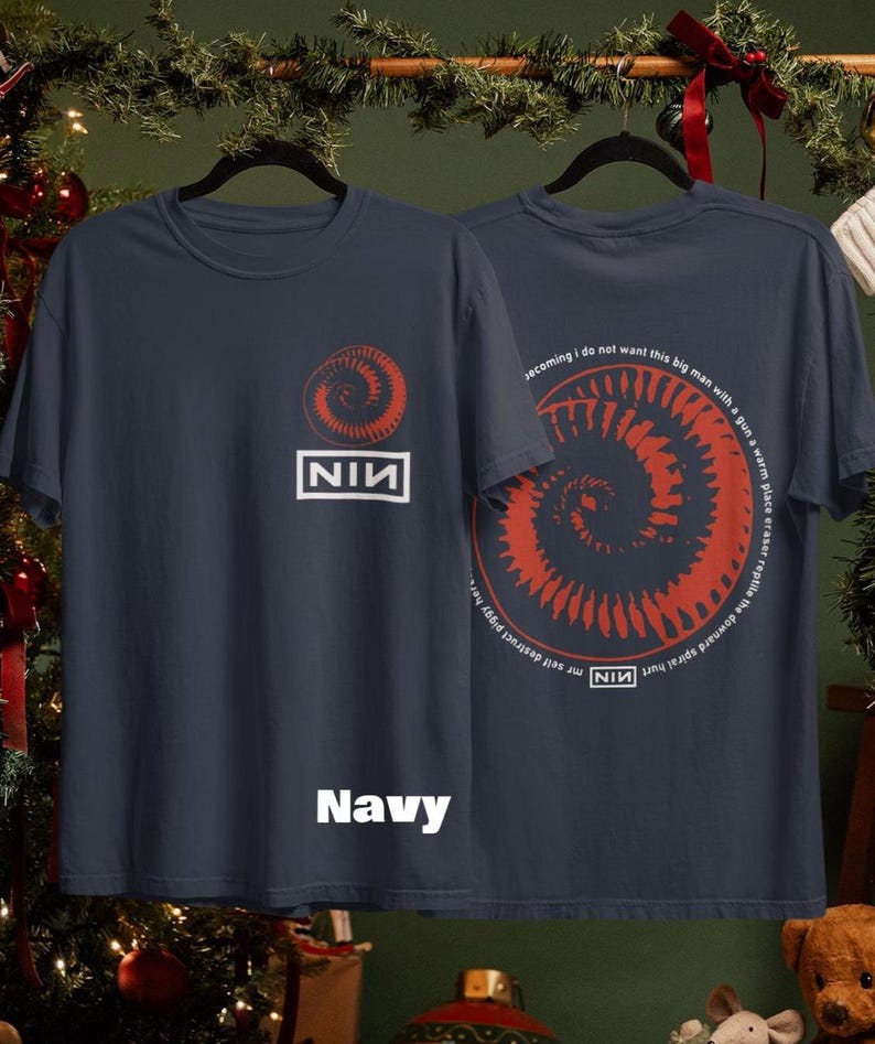 May include: Navy blue t-shirts with a red spiral design and the text "NIN" in a white rectangle. The back of the shirt features the spiral design and text. The word "Navy" is printed at the bottom of the shirt.