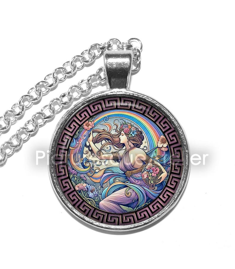 May include: A silver chain necklace with a round glass pendant featuring a colourful illustration of a woman with flowers in her hair, holding a flower-filled bowl, standing in front of a rainbow. The pendant is surrounded by a silver Greek key border.