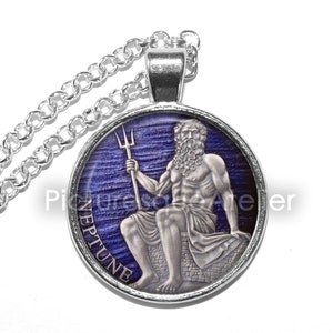 May include: Silver necklace with a round pendant featuring a blue and white image of Neptune, the Roman god of the sea, holding a trident. The pendant has the word "NEPTUNE" inscribed around the edge.