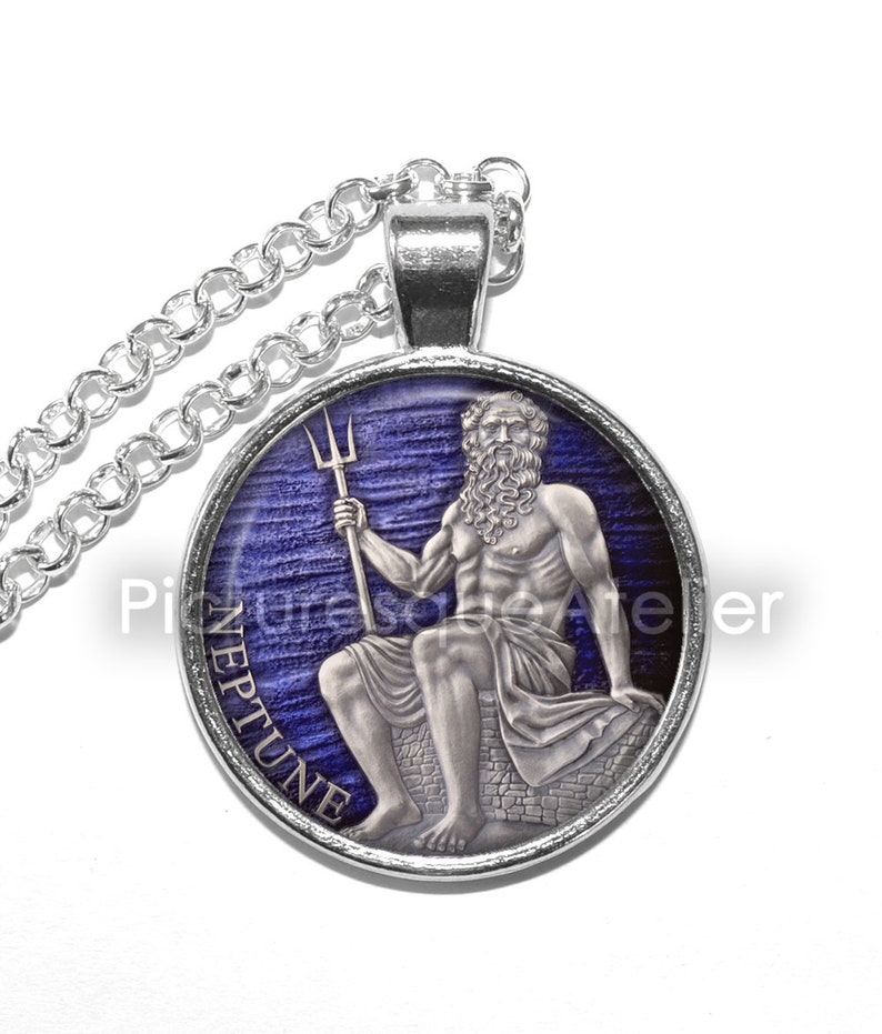 May include: Silver necklace with a round pendant featuring a blue and white image of Neptune, the Roman god of the sea, holding a trident. The pendant has the word "NEPTUNE" inscribed around the edge.