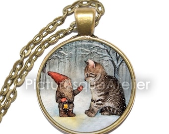 May include: A round glass pendant necklace with a bronze chain. The pendant features a painting of a gnome with a lantern and a cat in a snowy forest setting.