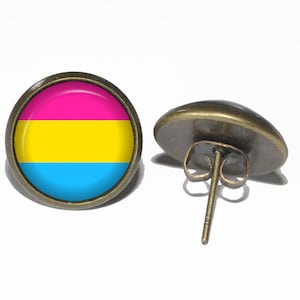 May include: A pair of earrings featuring a round, colorful design. The earrings are made of metal and have a post back. The design on the earrings is a pink, yellow, and blue flag.