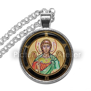 May include: A silver chain necklace with a round pendant featuring a colorful icon of an angel with wings and a halo. The pendant has a black background with gold lettering around the edge.