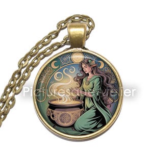 May include: A round pendant necklace with a bronze chain. The pendant features a fantasy illustration of a woman in a green dress, kneeling near a cauldron. The background has a blue and gold design.