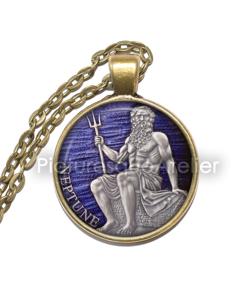 May include: A round pendant necklace with a gold chain. The pendant features a blue and silver image of Neptune, the Roman god of the sea, holding a trident. The pendant is inscribed with the word "Neptune".