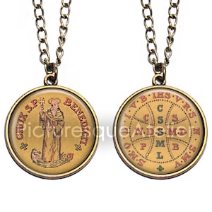 May include: A vintage-style pendant necklace with a bronze-colored chain. The round pendant features a detailed illustration of a religious figure and text. The reverse side displays a cross design with letters. The necklace is a religious item.