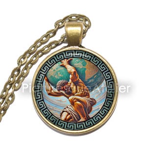 May include: A gold necklace with a round pendant featuring a painting of a muscular figure holding up the globe. The pendant is surrounded by a Greek key design.