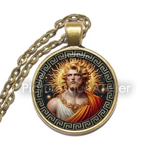 Könnte beinhalten: Goldfarbene Halskette mit Anhänger. Der runde Anhänger zeigt eine detaillierte Illustration eines Mannes mit Sonnenstrahlen-Heiligenschein. Der Anhänger hat einen griechischen Schlüssel-Rand und hängt an einer passenden Kette.