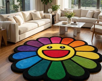 May include: A colorful, flower-shaped rug with a smiling face design. The rug features petals in various colors, including purple, blue, green, yellow, and orange, with a black border. The rug is placed on a hardwood floor in a living room setting.
