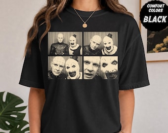 May include: A black t-shirt featuring a graphic print of four sepia-toned photo booth panels. The images depict Pinhead from Hellraiser and Art the Clown from Terrifier. A circular black badge in the top right corner reads COMFORT COLORS BLACK.
