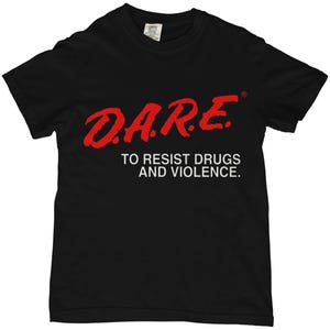 May include: Black t-shirt with the red text "D.A.R.E. TO RESIST DRUGS AND VIOLENCE." The shirt is a crew neck style and appears to be made of cotton. The D.A.R.E. logo is in a bold, stylized font.