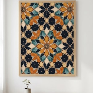 May include: A framed art print featuring a symmetrical floral pattern in shades of navy, teal, orange, and cream. The artwork is displayed in a light-colored wooden frame. The print is hanging on a white wall above a wooden table.