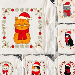 May include: A cream-colored t-shirt featuring a graphic of an orange tabby cat wearing a red Santa hat and a red scarf. The cat is centered within a square frame composed of holly leaves, red ornaments, and snowflakes, printed on the fabric.
