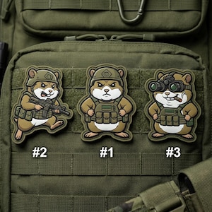 May include: Three tactical patches featuring cartoon hamsters in military gear. One hamster holds a rifle, another stands at attention, and the third wears night vision goggles and smokes a cigar. Each patch is numbered.