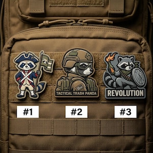 May include: Three embroidered patches featuring raccoon designs. One patch depicts a raccoon in a Revolutionary War uniform, another a raccoon in military gear with the text "Tactical Trash Panda", and the third a raccoon with a Molotov cocktail and shield with the text "Revolution".