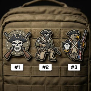 May include: Three embroidered patches with patriotic themes are displayed on a tan backpack. The patches feature a skull with crossed rifles, a soldier kneeling with a rifle, and an eagle holding a rifle and shield. Each patch has a number.