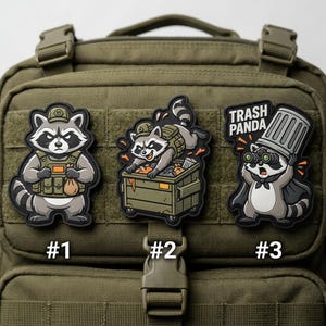 May include: Three cartoon raccoon patches. One raccoon wears a military-style vest and holds a bag. Another is in a dumpster. The third, labeled "Trash Panda," wears a cape and bin lid hat, holding binoculars.