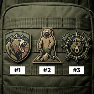 May include: Three embroidered patches featuring bear designs. One shows a roaring bear with mountains, another a standing bear on a mountain, and the third a bear with axes and a compass. Each patch has a number label.