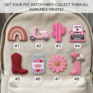 May include: Eight PVC patches arranged in two rows on a beige backpack. The designs include a rainbow, a pink scooter, a cactus, a typewriter with the text I LOVE YOU, a red cowboy boot, a jar of hearts labeled LOVE, a pink flower, and a pink boot with flowers.