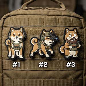 May include: Three tactical patches featuring Shiba Inu dogs in military gear. Each patch has a different design, with one wearing a headset, another with night vision, and the last with a beard and grenade. The patches are numbered #1, #2, and #3.