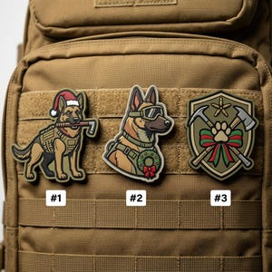 May include: Three tactical morale patches attached to a tan backpack. Patch #1 shows a German Shepherd in a Santa hat holding a tool. Patch #2 features a dog in tactical goggles with a holiday wreath. Patch #3 is a shield with axes and a paw print.