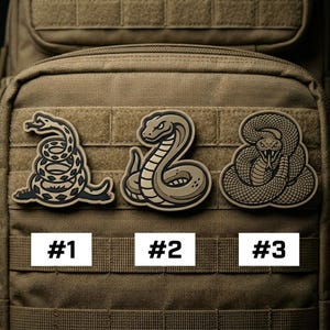 May include: Three snake patches in various designs. The first patch features a coiled snake with the text "Don't Tread on Me". The second patch depicts a cobra. The third patch shows a coiled snake with its fangs bared. Each patch is numbered.