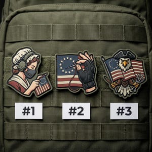 May include: Three embroidered patches featuring patriotic themes. One depicts a woman sewing a flag, another shows a hand sewing a flag, and the third features an eagle holding a flag. Each patch has a unique design and color scheme.