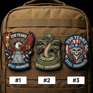 May include: Three patches with the text "250 YEARS STILL UNHINGED". One features an eagle, another a hydra, and the third a skull with a hat. Each patch has a unique design and color scheme, with the numbers #1, #2, and #3 below them.