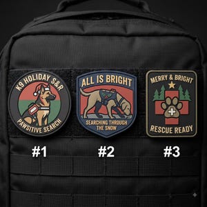May include: Three tactical morale patches attached to a black backpack. Patch 1 is circular with a German Shepherd wearing a Santa hat and text reading K9 HOLIDAY S&R PAWSITIVE SEARCH. Patch 2 is shield-shaped with a dog and text ALL IS BRIGHT SEARCHING THROUGH THE SNOW. Patch 3 is rectangular with a paw print, trees, and text MERRY & BRIGHT RESCUE READY.