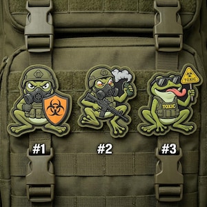 May include: Three green frog patches with military themes. One frog holds a shield with a biohazard symbol, another holds a rifle and a smoke grenade, and the third wears sunglasses and holds a "Toxic" sign. Each patch has a number.