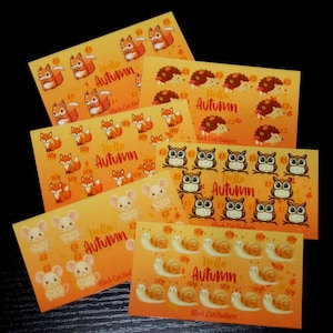 May include: A collection of rectangular orange sticker sheets featuring cartoon animals including squirrels, hedgehogs, foxes, owls, mice, and snails. Each sheet displays the text Hello Autumn and various currency values in British pounds.