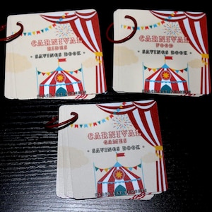 May include: Three square savings books bound with red metal rings. Each book features a cream-coloured cover with red and white striped carnival tent graphics, colourful bunting, and text reading Carnival Rides, Carnival Food, or Carnival Games.
