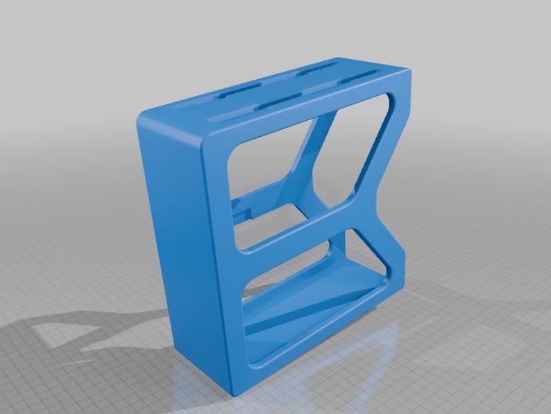 May include: A bright blue, rectangular, open-frame storage organizer featuring a solid top surface with three elongated slots and a hollow interior structure. The object has a geometric, angular design with a wide base and a slanted side profile.
