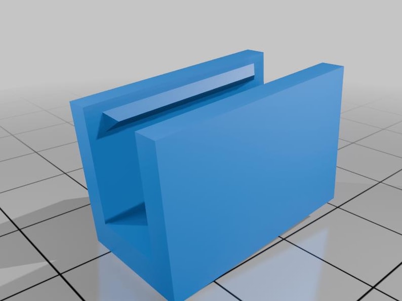May include: A bright blue U-shaped channel component with a rectangular profile and a smooth matte finish. The object features a central open cavity with a beveled inner edge along the top rim, presented in a clean, three-dimensional digital render.
