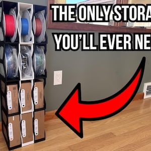 May include: A modular vertical storage rack with black and white frames, holding 3D printer filament spools and rectangular cardboard boxes. The text THE ONLY STORAGE YOU'LL EVER NEED is displayed above, with a large red arrow pointing to the rack.