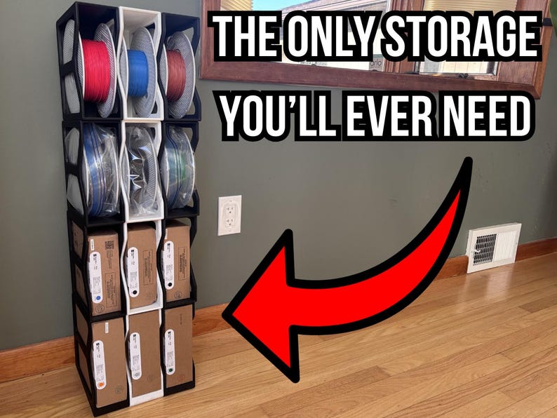 May include: A modular vertical storage rack with black and white frames, holding 3D printer filament spools and rectangular cardboard boxes. The text THE ONLY STORAGE YOU'LL EVER NEED is displayed above, with a large red arrow pointing to the rack.