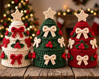 May include: Three cone-shaped crochet containers shaped like Christmas trees. The left is cream with red bows, the center is green with cream bows, and the right is red with cream bows. Each features a star topper and holly berry accents.
