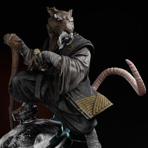 May include: A detailed statue of a rat-like figure in a crouching pose, dressed in a dark gray robe with gold accents. The figure holds a katana and a wooden staff, with a long tail curving upwards. The statue has a stern expression.