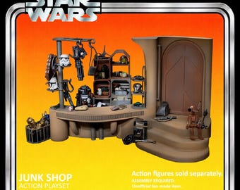 May include: A Star Wars "Junk Shop" action playset designed for 6" figures. The playset features a detailed shop interior with various accessories and a brown and tan color scheme. The packaging includes the Star Wars logo and text that reads "Ages 40 and up."